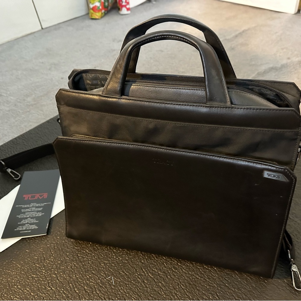 Black excellent condition TUMI laptop leather bag.